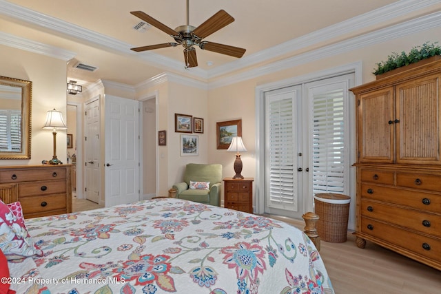 bedroom with light wood-type flooring, ceiling fan, and crown molding