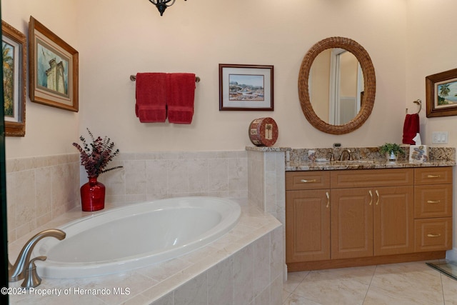 bathroom with tiled bath and vanity