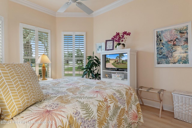 bedroom featuring light wood-type flooring, ceiling fan, and crown molding