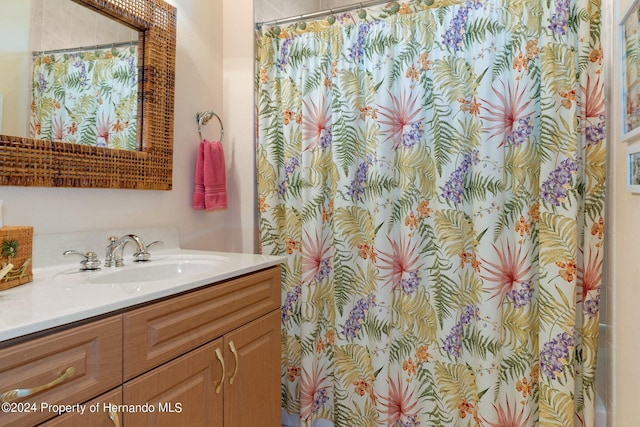9312 Gentle Ben Ct, Weeki Wachee, FL 34613 - bathroom with vanity and curtained shower