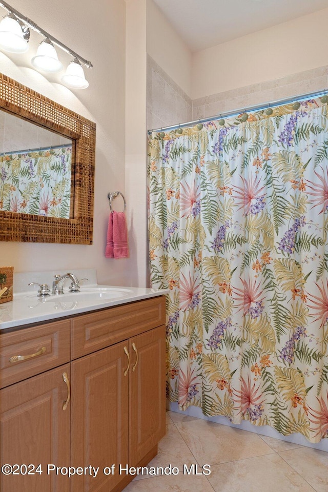 9312 Gentle Ben Ct, Weeki Wachee, FL 34613 - full bathroom featuring vanity, a shower with curtain, and tile patterned floors