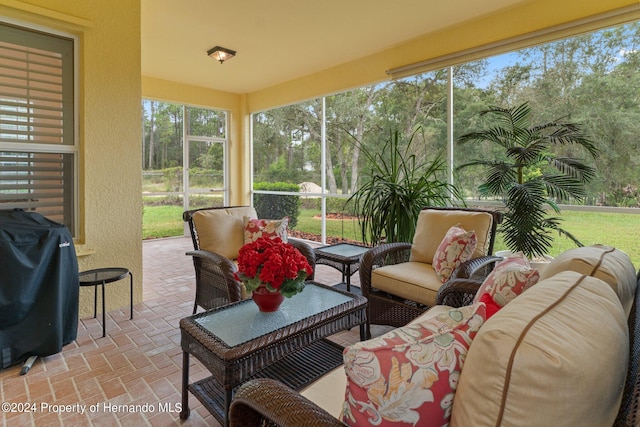 9312 Gentle Ben Ct, Weeki Wachee, FL 34613 - sunroom / solarium with outdoor lounge area and view of wooded area