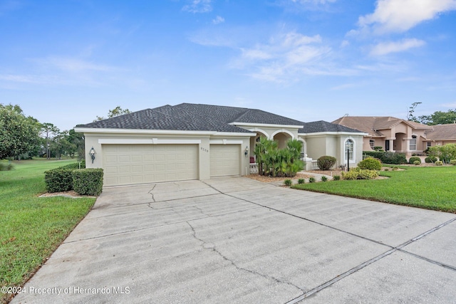 view of front of property featuring a garage and a front yard