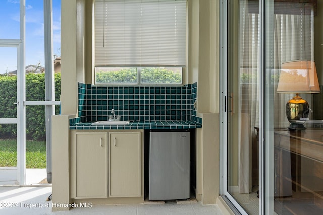 bathroom with sink and tasteful backsplash