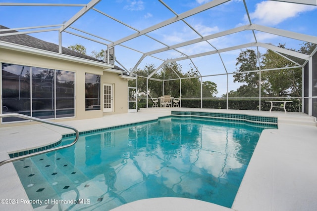 view of swimming pool with a lanai and a patio