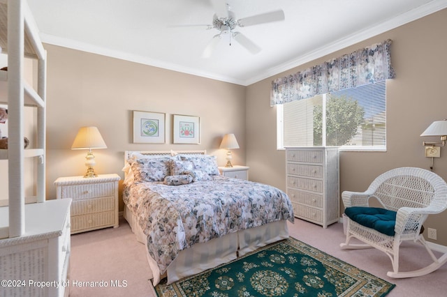 carpeted bedroom featuring ceiling fan and crown molding