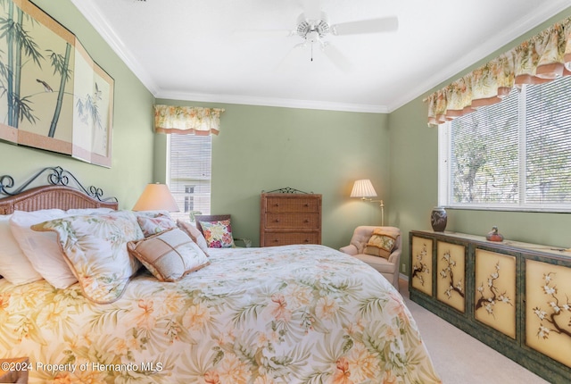 carpeted bedroom with ornamental molding and ceiling fan