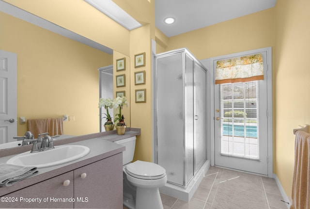 bathroom with vanity, a shower with shower door, tile patterned flooring, and toilet