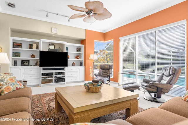 living room featuring rail lighting, carpet flooring, ceiling fan, and crown molding