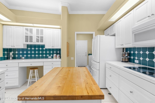 kitchen with white cabinetry, white appliances, decorative backsplash, and crown molding