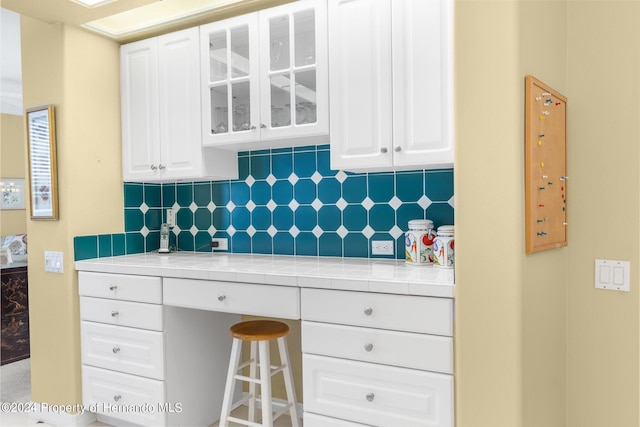 kitchen with white cabinets and backsplash