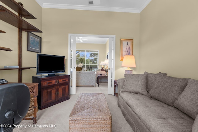 carpeted living room featuring ornamental molding and ceiling fan