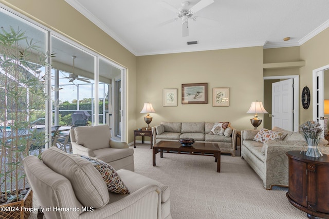 carpeted living room with ornamental molding and ceiling fan