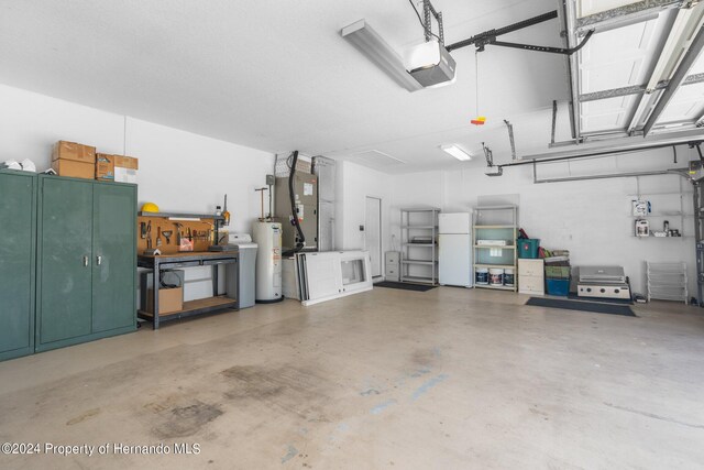 garage with water heater, a garage door opener, heating unit, and white refrigerator