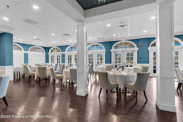 dining space with dark wood-type flooring and french doors