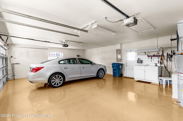 garage with electric panel and a garage door opener