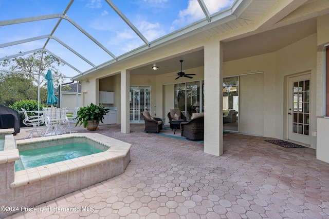 view of swimming pool featuring an in ground hot tub, a patio area, an outdoor living space, a lanai, and ceiling fan