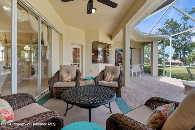 sunroom featuring ceiling fan