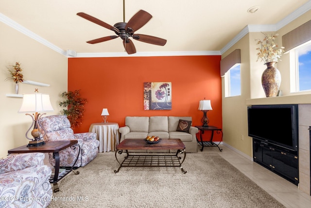 living room featuring light tile patterned flooring, ceiling fan, a healthy amount of sunlight, and ornamental molding