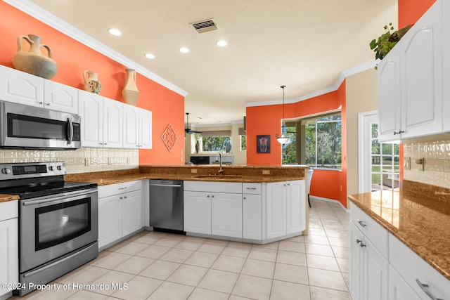 kitchen with white cabinetry, appliances with stainless steel finishes, plenty of natural light, pendant lighting, and sink