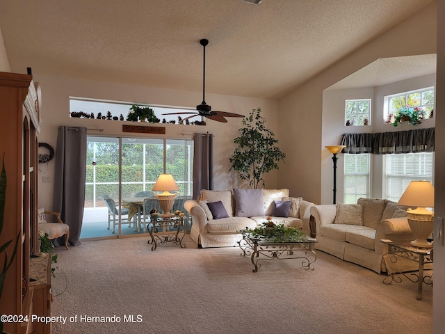 carpeted living room featuring a textured ceiling and ceiling fan