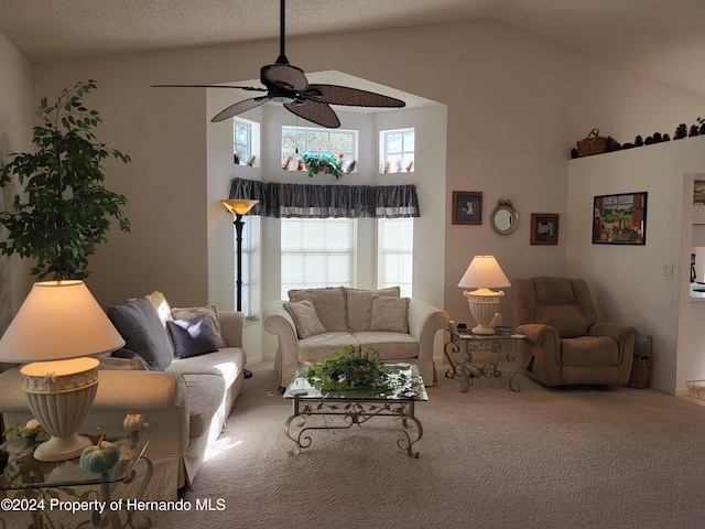 carpeted living room with high vaulted ceiling, a textured ceiling, and ceiling fan