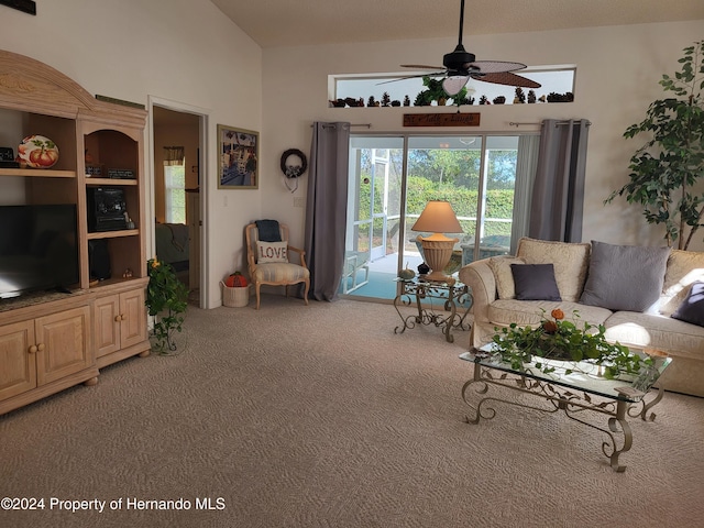 living room with ceiling fan, vaulted ceiling, and carpet