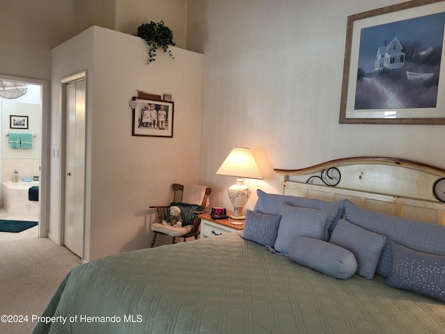 carpeted bedroom featuring ensuite bath