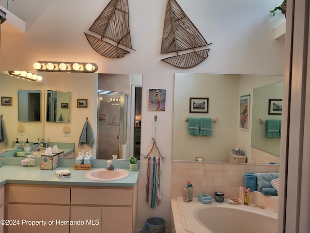 bathroom with shower with separate bathtub and vanity