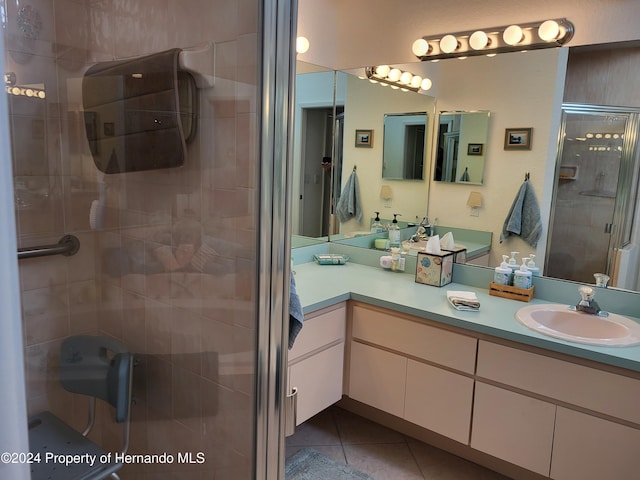 bathroom with vanity, tile patterned floors, and a shower with door