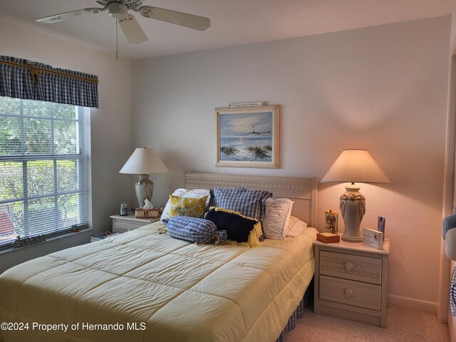 carpeted bedroom with ceiling fan