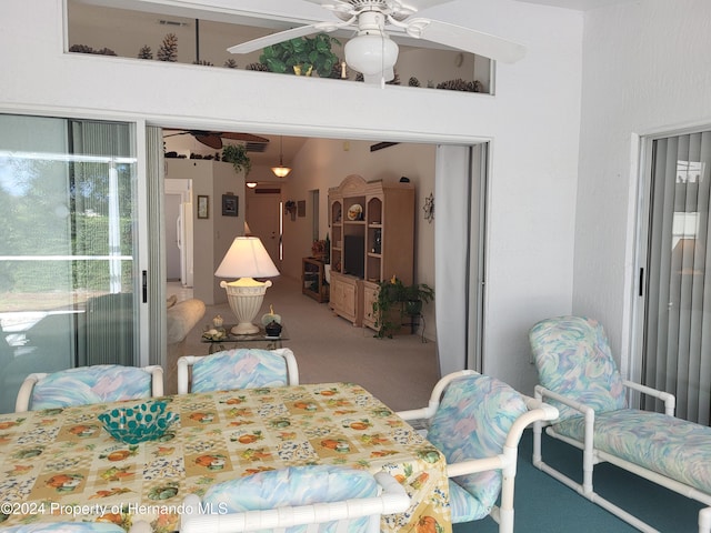 carpeted dining area featuring ceiling fan