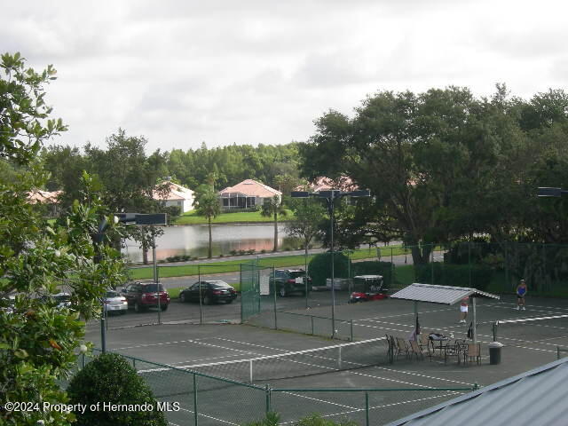 view of sport court with a water view