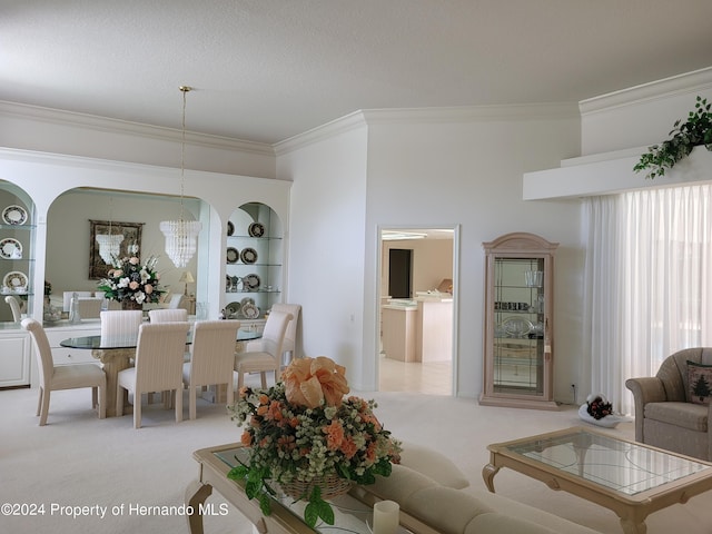 dining room featuring ornamental molding, a chandelier, light carpet, and built in features