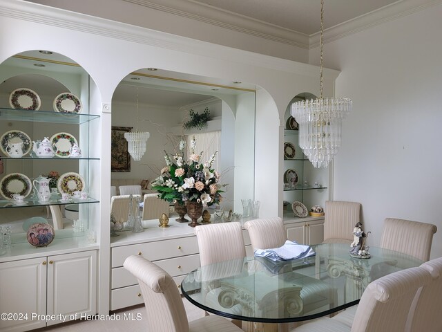 dining area with an inviting chandelier and crown molding