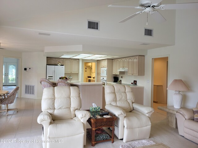 living room with ceiling fan and vaulted ceiling