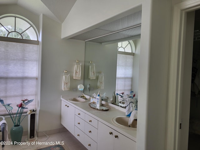 bathroom featuring vanity, tile patterned floors, and vaulted ceiling