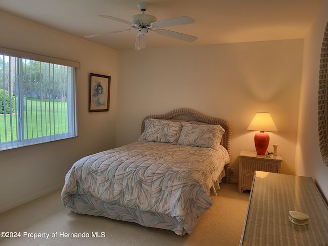 carpeted bedroom featuring ceiling fan and multiple windows