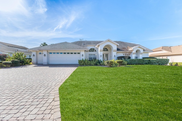 single story home featuring a front yard and a garage