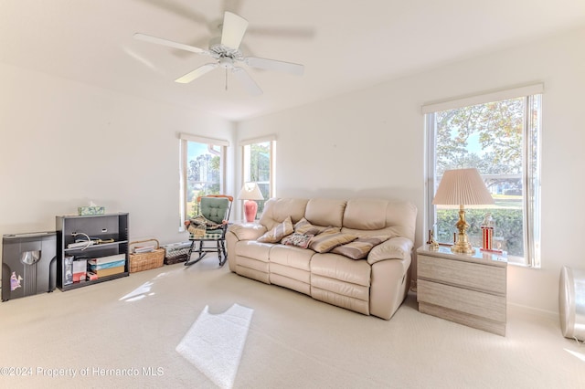 carpeted living room with ceiling fan