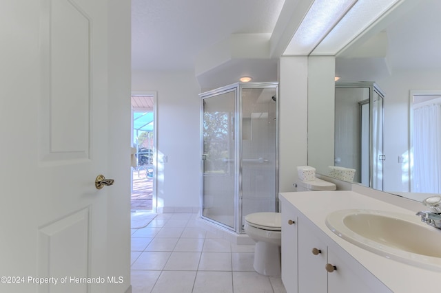 bathroom featuring a shower with door, vanity, tile patterned floors, and toilet