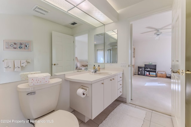 bathroom with toilet, tile patterned flooring, vanity, and ceiling fan