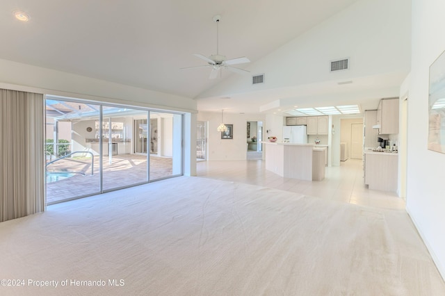 unfurnished living room with ceiling fan, light carpet, and high vaulted ceiling