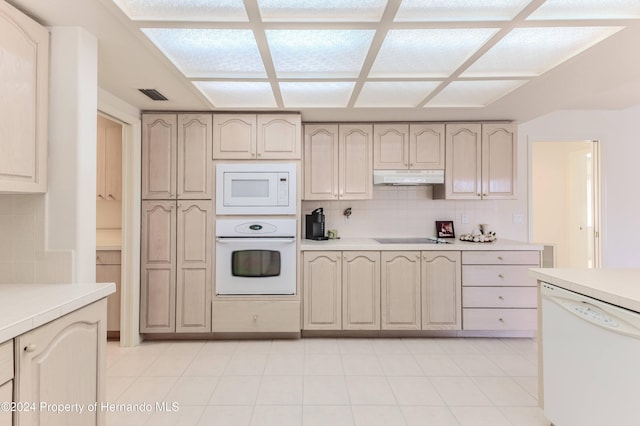 kitchen featuring white appliances, light tile patterned floors, and tasteful backsplash