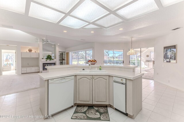 kitchen featuring dishwasher, hanging light fixtures, light tile patterned floors, ceiling fan, and sink