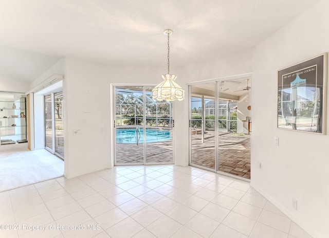 unfurnished dining area with light tile patterned flooring and a notable chandelier