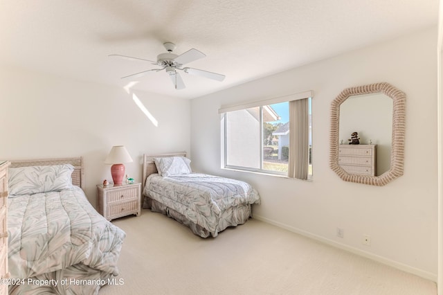 bedroom with ceiling fan and carpet flooring