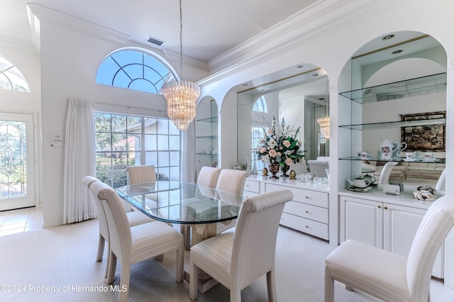 carpeted dining room featuring built in features, crown molding, and a chandelier