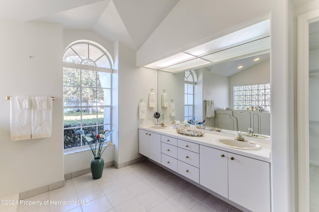 bathroom with vanity, tile patterned floors, and vaulted ceiling