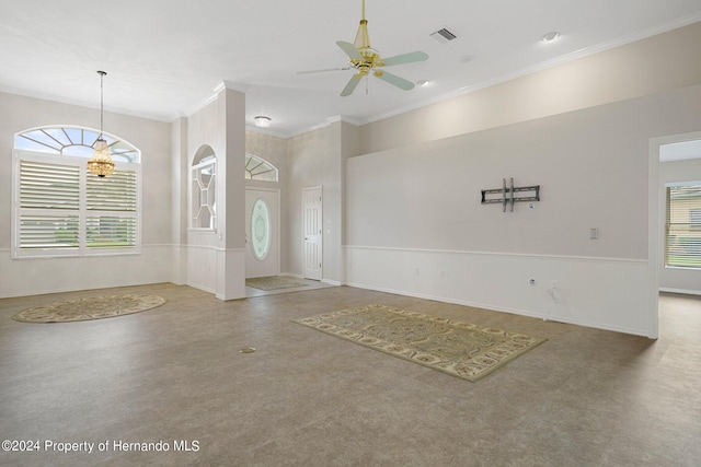 entrance foyer with ornamental molding and ceiling fan